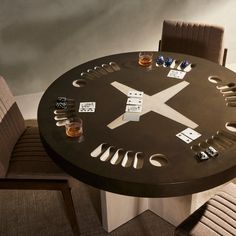 a table that has some sort of clock on it with different items around it and two chairs next to it