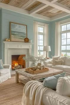 a living room filled with furniture and a fire place in front of two windows on either side of the fireplace