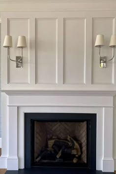 a fire place with two lamps on either side