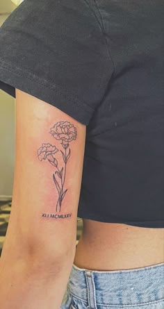 a woman's arm with a flower tattoo on the left side of her body