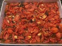 a pan filled with lots of red tomatoes