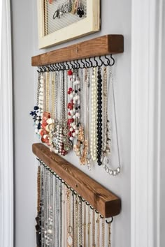 a bunch of necklaces hanging on a wall next to a door with an instagram message