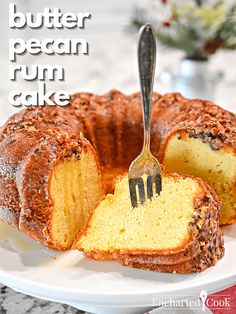 a bundt cake on a plate with a fork stuck in it and the words, butter pecan rum cake