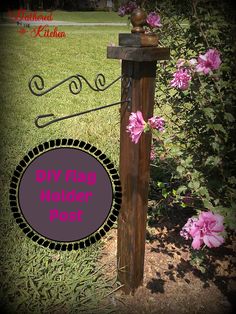 a wooden post with pink flowers on it and the words diy flag holder post