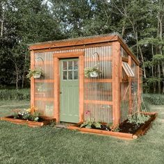 a small garden shed with plants growing out of it