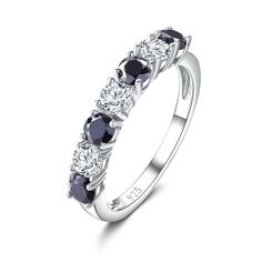 a white gold ring with black and white diamonds