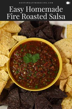 homemade fire roasted salsa in a yellow bowl surrounded by tortilla chips