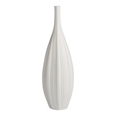 a white vase sitting on top of a table