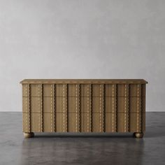 a large wooden dresser sitting on top of a floor next to a white wall and grey walls