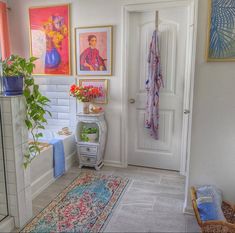 a bathroom with pictures on the wall and rug