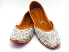 Durable, hand-stitched shoes in the ethnic Indian/Pakistani design, with a leather-padded cushion inside and a genuine leather sole. These exquisite khussa are made of a white raw silk foundation that is adorned with silver beads in a symmetrical pattern. These shoes are perfect for special occasions as well as everyday usage. Among our most beloved shoe selections for formal events like weddings. These shoes can look great on you with any type of attire. These will make you fall in love, whether you buy them for yourself or as a gift for a friend. To view more of our selection, visit our page! We ship out in a timely matter, wrapped in care for a safe secure trip to your location. Thank you for supporting our small business! Shipped from USA. Sizes available US 5,6,7,8,9,10,11. Juti Shoes Pattern, Embroidered Leather Flats With Flat Heel, Leather Embroidered Flats, Embroidered Leather Slip-on Flats, Festive Embroidered Leather Flats, Traditional Embroidered Round Toe Flats, Handwork Leather Closed Toe Flats, Handwork Leather Closed-toe Flats, Traditional Embroidered Slip-on Flats