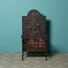 an old wooden bench sitting in front of a blue wall with a pattern on it