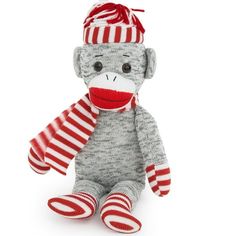 a sock monkey with a red and white striped hat on it's head sitting