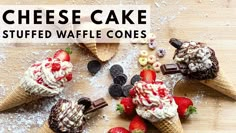 three ice cream cones with strawberries and chocolate on top, sitting on a cutting board