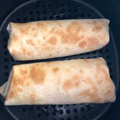 two burritos cooking in a frying pan