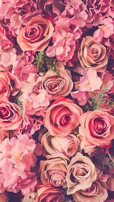 an arrangement of pink and red flowers