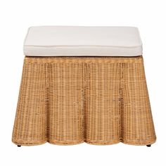 a wicker bench with a white cushion on the top and bottom layer, sitting in front of a white background