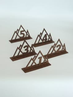 three wooden numbers are placed on top of each other in the shape of trianglees