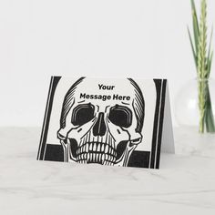 a card with a skull on it and the words your message here written in black