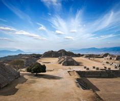 an aerial view of the ancient city of tempish with mountains in the background