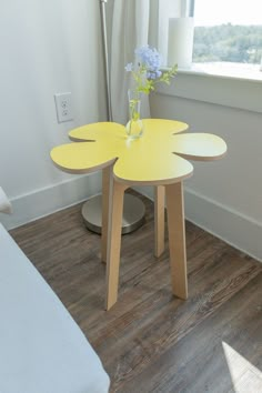 two tables with flowers on them in front of a window