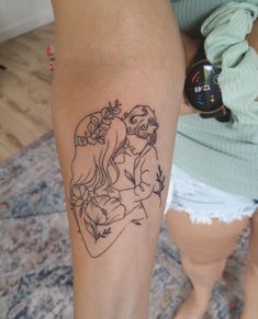 a woman with a tattoo on her leg