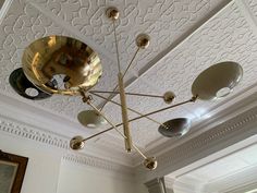 a chandelier hanging from the ceiling in a room with white walls and ceilings