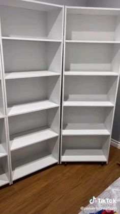 two white bookcases sitting next to each other