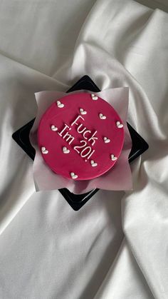 a red cake with white hearts on it sitting on top of a black and white cloth