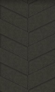 a close up view of the side of a dark green leather textured material background