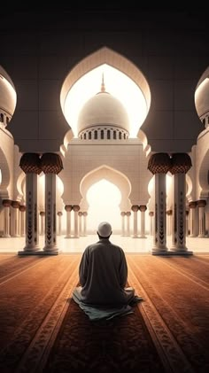 a man sitting in the middle of a room with arches and pillars on either side