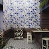 a kitchen with blue and white tiles on the walls, flooring and counter tops