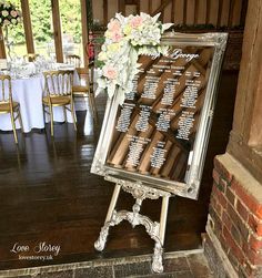 a wedding seating chart is set up on an easel