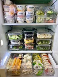 an open refrigerator filled with lots of food and containers full of different types of vegetables