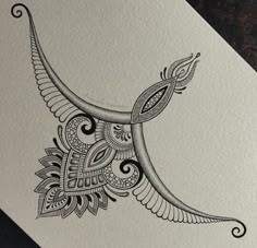 an intricately designed bird is shown on a piece of white paper with black ink