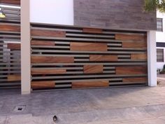 a modern garage door with wooden slats on the side