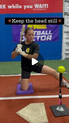 a woman in black shirt and shorts holding a baseball bat on top of a purple mat