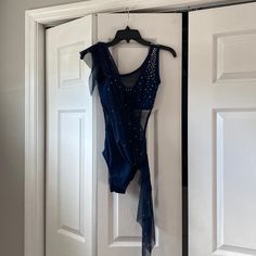 a blue dress hanging on a white door