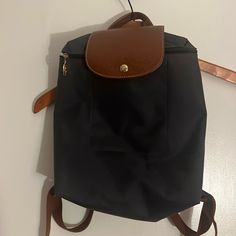 Longchamp Le Pliage Backpack In Black Nylon With Adjustable Straps Height 31cm (12.2 In) Width 24.5cm (9.65 In) Gusset 10cm (3.94 In). Black Rectangular Nylon Backpack, Standard Nylon Backpack For On-the-go, Longchamp Le Foulonne Backpack, Longchamp Le Pilage Backpack, Longchamp Expandable Travel Bag, Longchamp Bags, Longchamp Le Pliage Backpack, Black Nylons, Longchamp Le Pliage