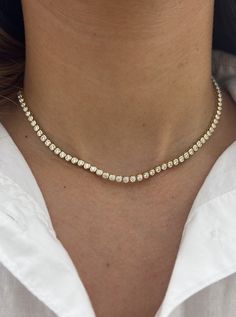 A classic tennis necklace for any occasion. This 3.50 ct of diamonds are bezel set on our classic Tennis Choker chain for an adjustable style. The perfect piece to start layering! 14k Yellow Gold or White Gold 3.50ct tw Necklace, 8.5" of diamonds with 6" of adjustable rings Diamond Color: F/G, Clarity: SI1 Made to Order. Lead time is 2-4 weeks. Benefits of Solid 14k Gold Jewelry Most loved for its durability and longevity Can be worn daily and requires less maintenance and care than plated, verm Bezel Tennis Necklace, Tennis Chain Necklace, Gold Tennis Necklace, Layering Diamond Necklaces, Bezel Set Necklace, Triple Layer Necklace, Gold Cupcakes, Tennis Jewelry, Diamond Tennis Necklace