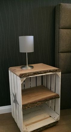 a small wooden table with a lamp on top