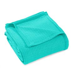 the aqua blue blanket is folded on top of each other, and it looks like they are