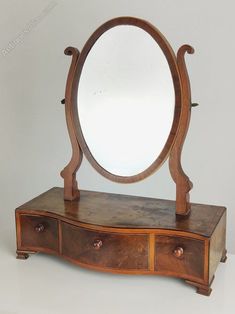 an old wooden dresser with a mirror on top