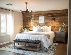 a bedroom with wood paneling and white bedding