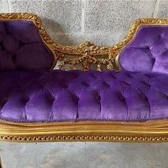 a purple and gold chaise lounge chair