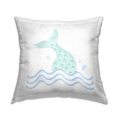 a white pillow with a blue whale on it