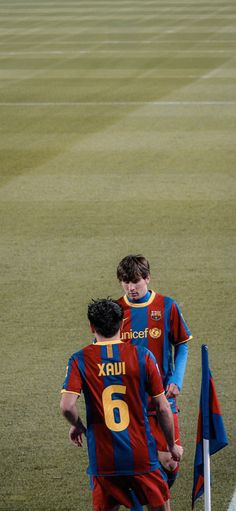 two soccer players congratulate each other on the field