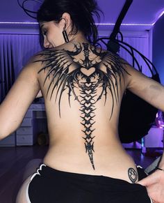 a woman with a tattoo on her back