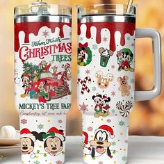 two mickey mouse christmas themed travel mugs