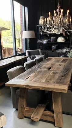 a large wooden table sitting inside of a living room